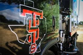 Texas Site Services branding on the side of a sweeping truck