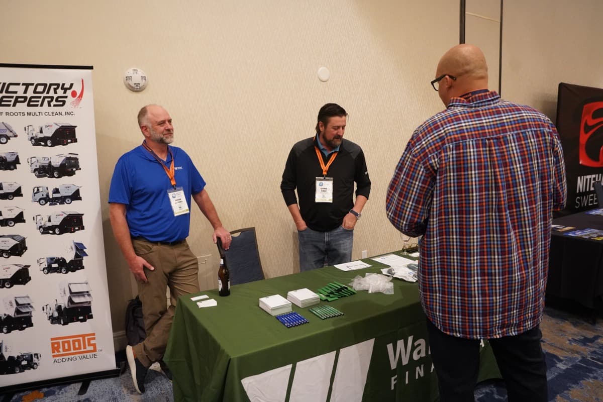 Exhibitors connecting with attendees at their booth