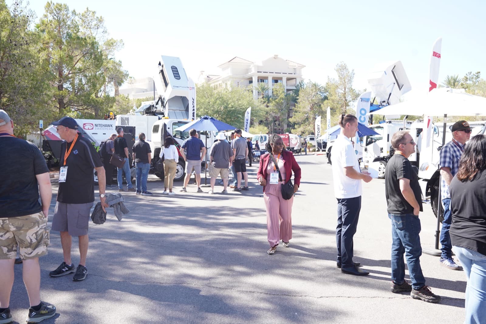 Outdoor equipment expo with sweeper trucks on display